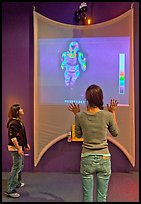 Girls play with thermal imaging camera, Tech Museum. San Jose, California, USA ( color)