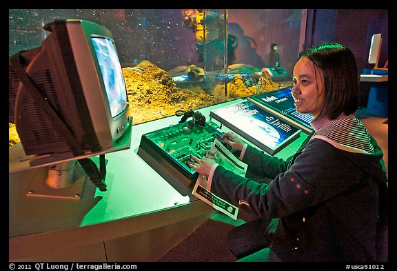 Woman controls robot, Tech Museum. San Jose, California, USA
