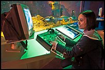 Woman controls robot, Tech Museum. San Jose, California, USA ( color)