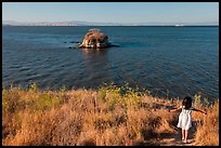 Girl on San Pablo Bay grassy shore, China Camp State Park. San Pablo Bay, California, USA (color)