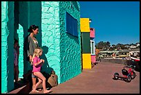 Family steps out of colorful cottage. Capitola, California, USA ( color)