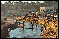 Children playing in tidal stream. Capitola, California, USA (color)