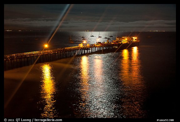 Wharf with moon reflections and light rays. Capitola, California, USA (color)
