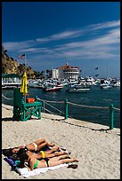 Women sunning on beach near harbor, Avalon, Catalina. California, USA (color)