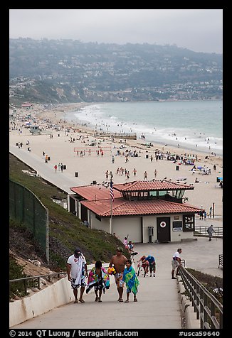 Beachgoers walking up from beach, Redondo Beach. Los Angeles, California, USA (color)