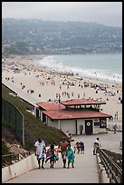 Beachgoers walking up from beach, Redondo Beach. Los Angeles, California, USA ( color)