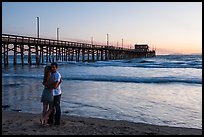 Couple embracing in front of Newport Pier. Newport Beach, Orange County, California, USA ( color)