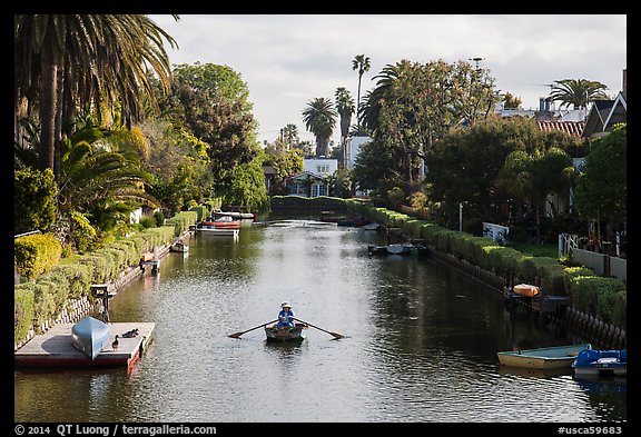 Woman rowing in canal. Venice, Los Angeles, California, USA (color)