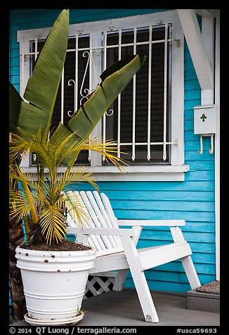 Matching white garden chair, flower pots, and window on porch. Venice, Los Angeles, California, USA (color)
