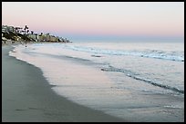 Beach at sunset with colors of sky reflected in wet sand. Laguna Beach, Orange County, California, USA ( color)