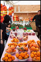 Customers buying fruit at stand. California, USA ( color)