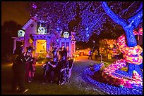Revelers in Halloween costumes in decorated yard. Petaluma, California, USA ( color)