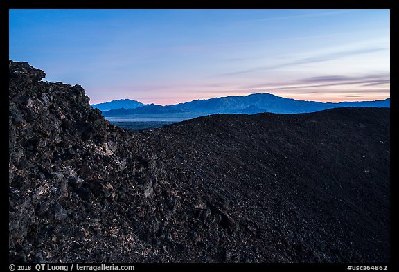 Rim of Amboy Crater and mountains at dusk. Mojave Trails National Monument, California, USA