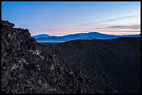Rim of Amboy Crater and mountains at dusk. Mojave Trails National Monument, California, USA ( color)