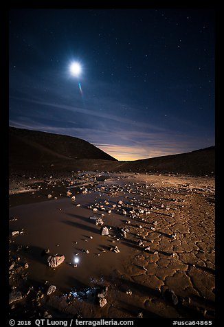 Puddle and cracked mud in Amboy Crater at night. Mojave Trails National Monument, California, USA (color)