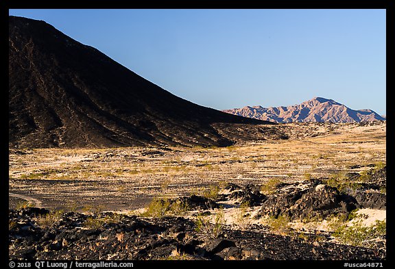 Lava field, Amboy Crater slope and mountains. Mojave Trails National Monument, California, USA