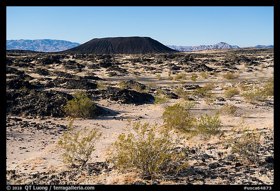 Volcanic terrain with Amboy Crater extinct cinder cone volcano. Mojave Trails National Monument, California, USA