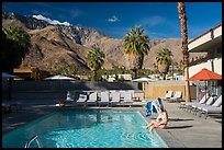Woman at swimming pool and San Jacinto Mountains, Palm Springs, Palm Springs. California, USA ( color)