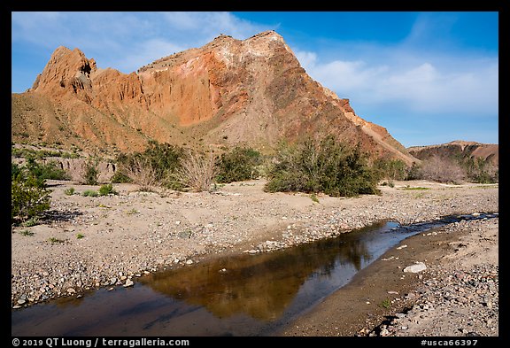 Colorful cliffs rise above the Mojave River in Afton Canyon. Mojave Trails National Monument, California, USA