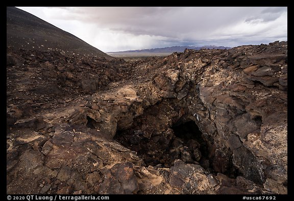 Pisgah Cinder cone and entrance to lava tube cave. Mojave Trails National Monument, California, USA