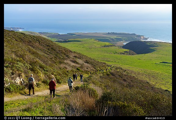 Group hiking above grassy marine coastal terrace. Cotoni-Coast Dairies Unit, California Coastal National Monument, California, USA (color)