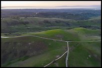 Aerial view of roads, gently rolling hills, with Pacific Ocean in the distance. California, USA ( color)