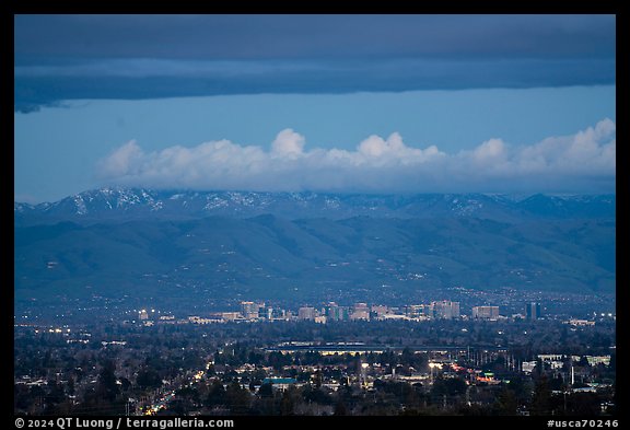 Apple headquarters, San Jose skyline, and snowy Mt Hamilton Range at dusk. San Jose, California, USA (color)