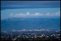 Apple headquarters, San Jose skyline, and snowy Mt Hamilton Range at dusk. San Jose, California, USA ( color)