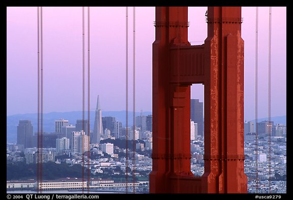 City through cables and pilars of Golden Gate bridge, dusk. San Francisco, California, USA