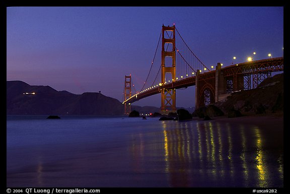Golden Gate bridge and surf with light reflections, seen from E Baker Beach, dusk. San Francisco, California, USA