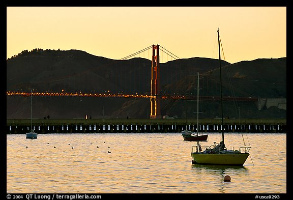 Sailboat in the Marina, with Golden Gate Bridge at sunset in the background. San Francisco, California, USA