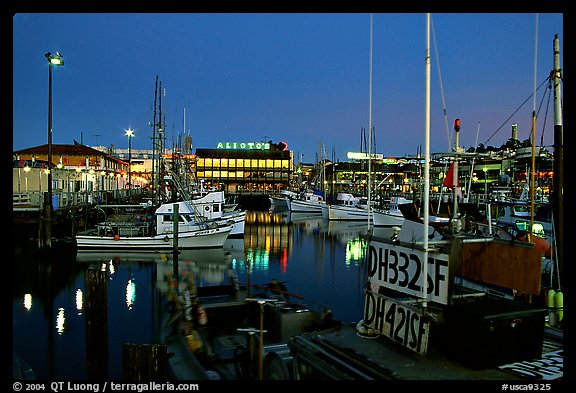 Fishing boat in Fisherman's Wharf, with Alioto's in the background, dusk. San Francisco, California, USA (color)