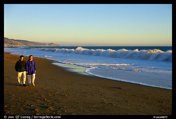 Couple strolling on the beach, late afternoon. Point Reyes National Seashore, California, USA (color)
