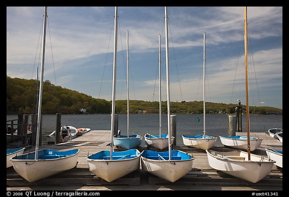 Small sailboasts parked on deck and Mystic River. Mystic, Connecticut, USA (color)