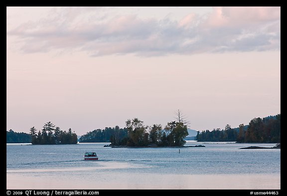 Motorboat and islets at sunset,  Moosehead Lake, Greenville. Maine, USA