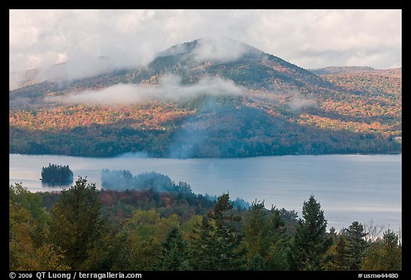Autumn scenery with lake and clouds lifting up. Maine, USA