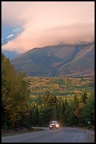 Truck on road below cloud-capped Katahdin. Maine, USA (color)