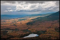 View with storm light and clouds over slopes covered with fall foliage. Baxter State Park, Maine, USA ( color)