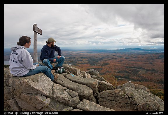 Hikers taking in view near sign marking summit of South Turner Mountain. Baxter State Park, Maine, USA (color)
