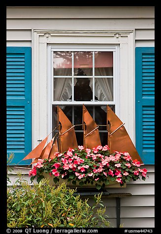 Window with decorative sailboat and flowers. Bar Harbor, Maine, USA