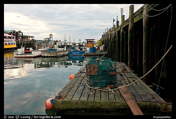 Lobster traps and fishing boats below pier. Portland, Maine, USA