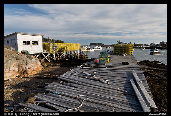 Deck, lobster traps, and harbor. Corea, Maine, USA