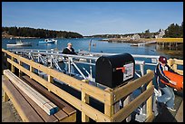 Mailbox and people unloading mailboat. Isle Au Haut, Maine, USA ( color)