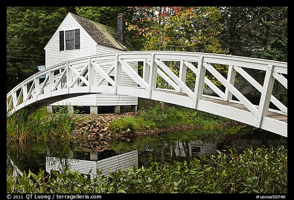 Arched bridge over mill pond. Maine, USA