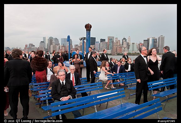 Black Tie gala guests on boat deck, New York harbor. NYC, New York, USA