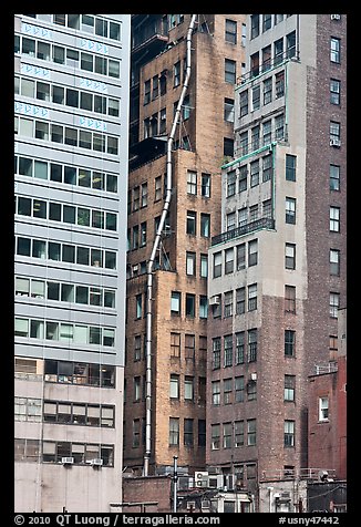 Old high-rise buildings with exterior pipe. NYC, New York, USA (color)