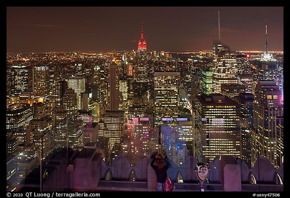 Woman on observation platform of Rockefeller center at night. NYC, New York, USA
