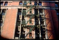 Emergency exit staircases on the side of a building. NYC, New York, USA (color)