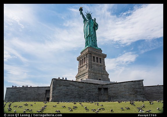 Statue of Liberty from lawn with pigeons, Statue of Liberty National Monument. NYC, New York, USA