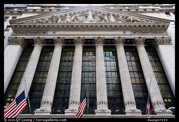 Looking up New York Stock Exchange with flags at half-mast. NYC, New York, USA (color)